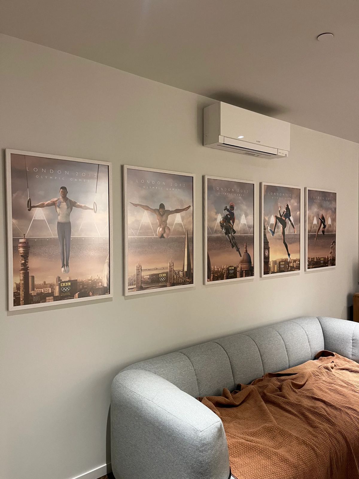Five matching framed prints hung in a row