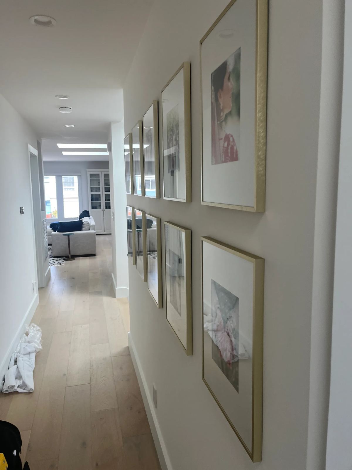 Gallery wall of framed art installed in a hallway