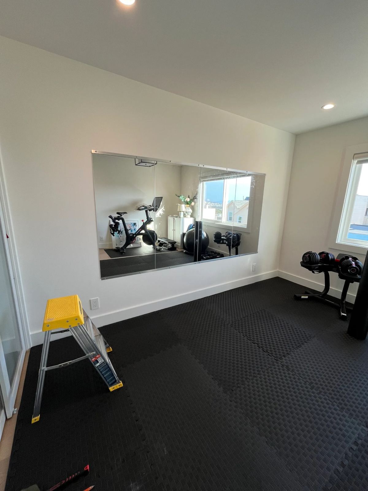 Large mirror mounted on a wall in a home gym