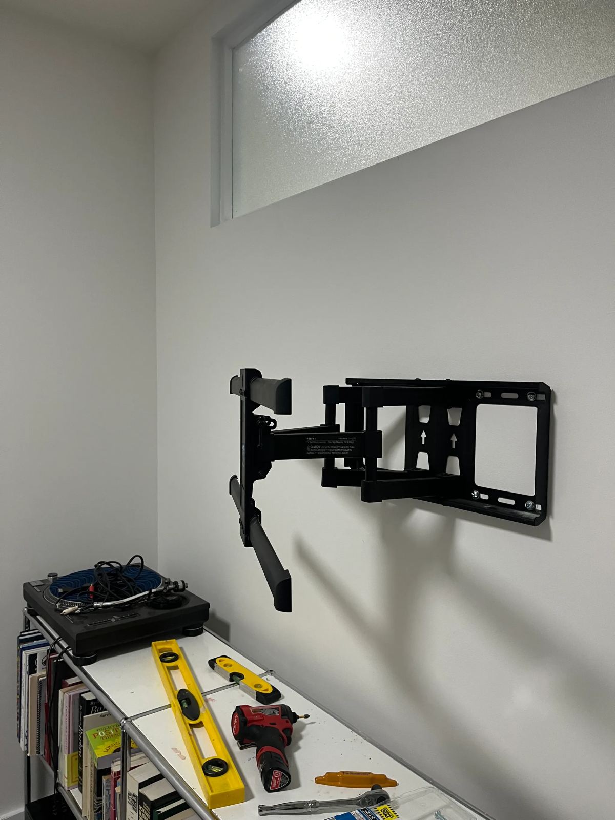 TV wall-mount installation with bracket and level