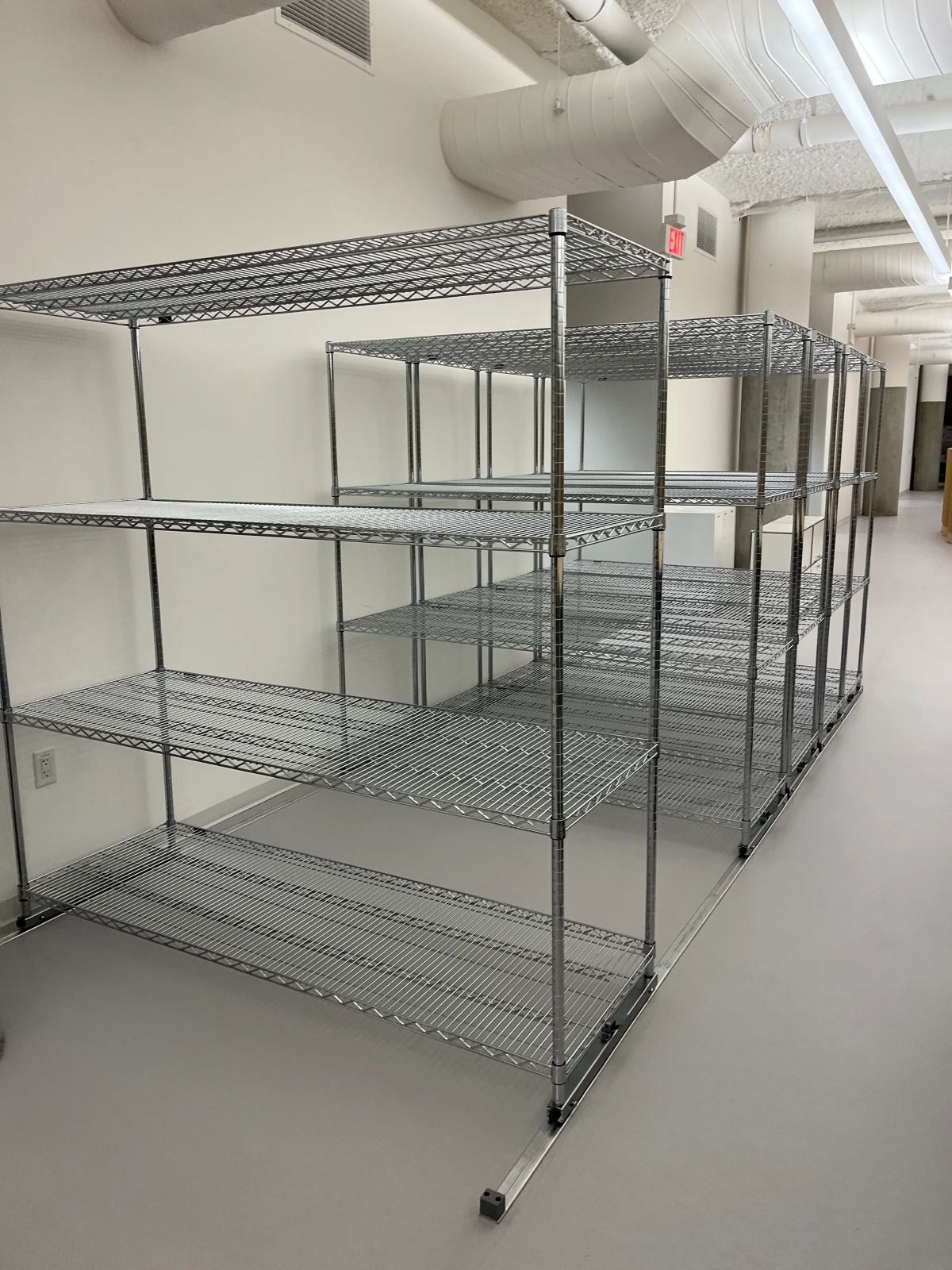 Rows of assembled wire shelving in a warehouse space